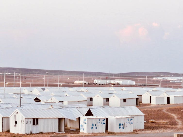 A plot of empty white shelters.